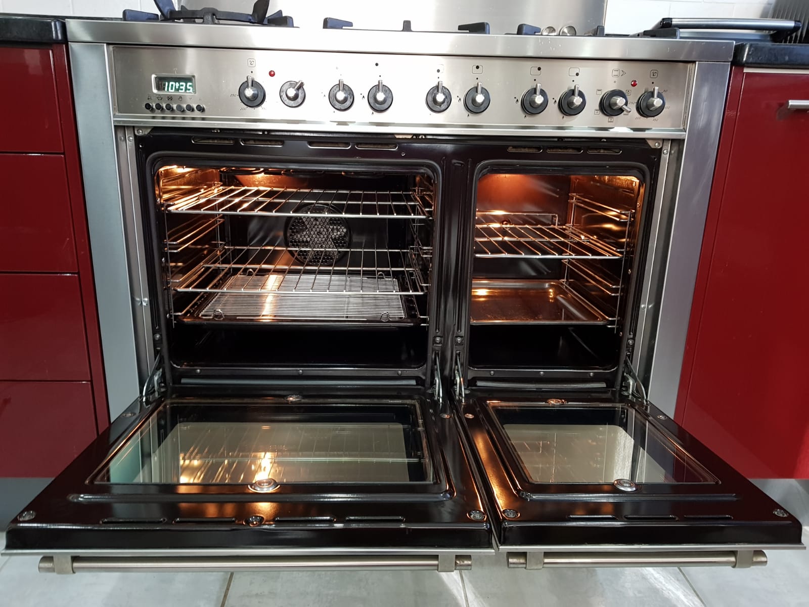 Clean range oven with both doors open and warm interior lighting